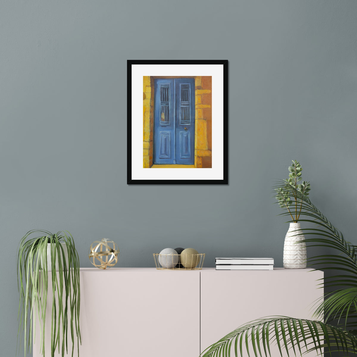 Blue Door art print, 16x20, in a black frame with white mat, hanging on a wall in a furnished room